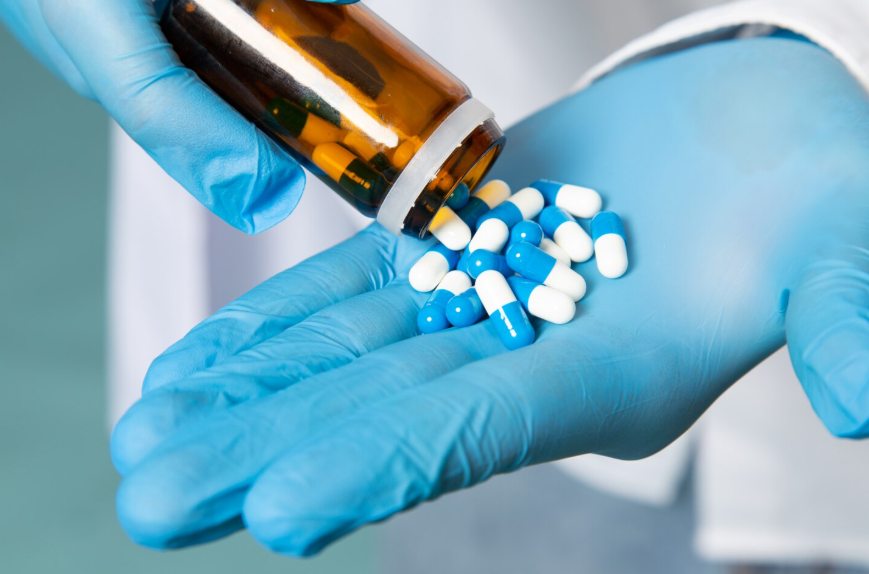 why antibiotic resistance is dangerous illustrated by antibiotics in gloved medical hand